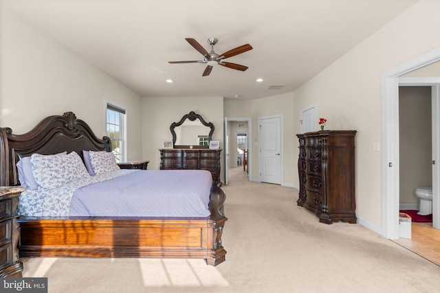 carpeted bedroom with ceiling fan and ensuite bathroom