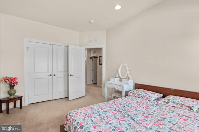 bedroom with a closet and light colored carpet