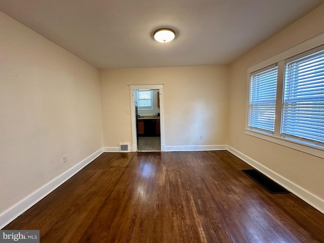 spare room featuring dark wood-type flooring