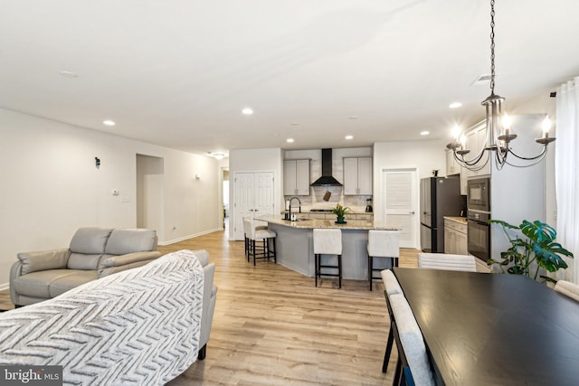 living room with sink and light hardwood / wood-style floors