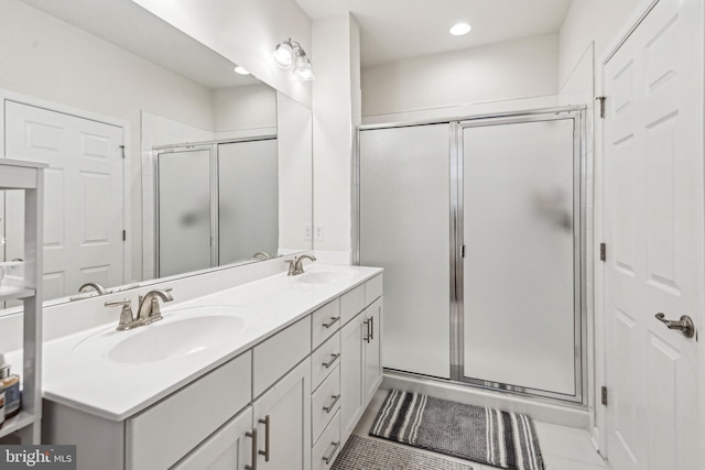 bathroom featuring tile patterned floors, an enclosed shower, and vanity