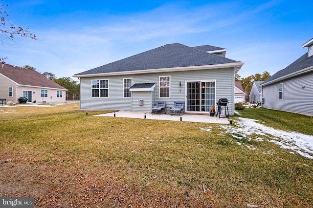 rear view of property featuring a yard and a patio