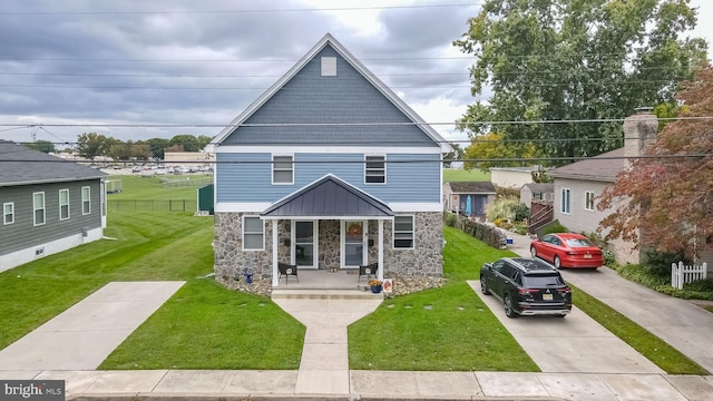 view of front of home with a porch and a front lawn