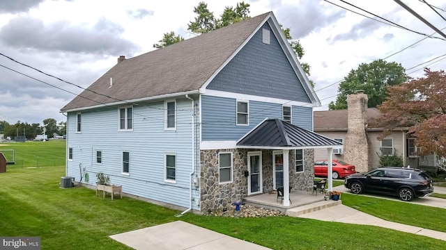 view of front facade with central AC unit and a front lawn