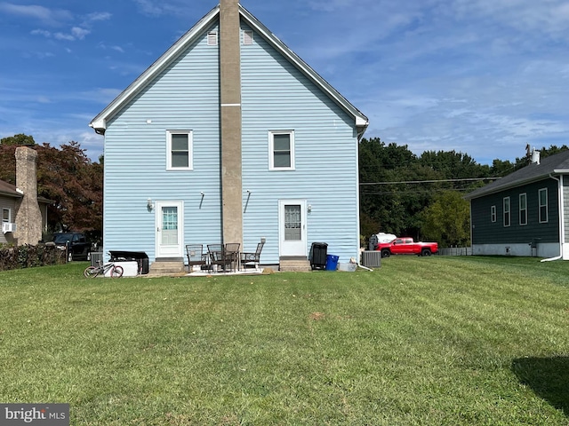 back of property with a lawn