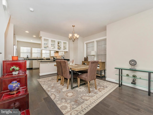 dining area featuring dark hardwood / wood-style flooring and a notable chandelier