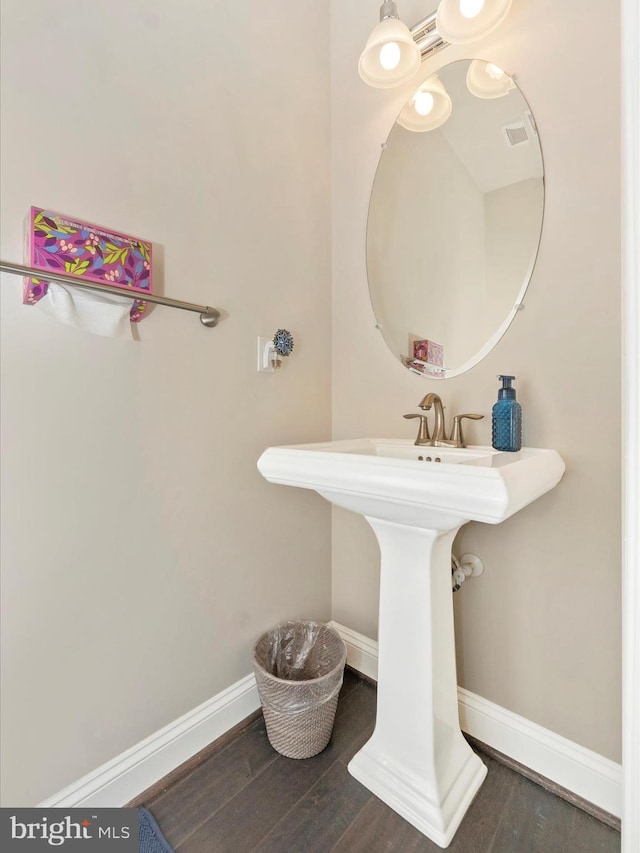 bathroom with hardwood / wood-style flooring and sink