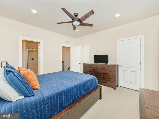 carpeted bedroom featuring ceiling fan and connected bathroom