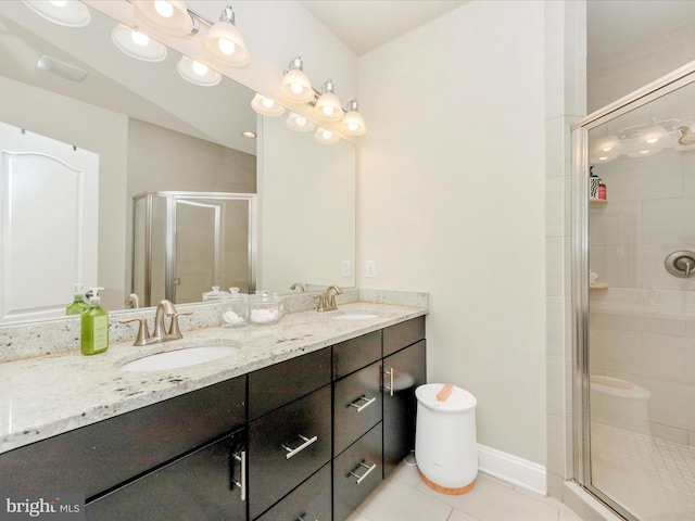 bathroom with tile patterned floors, vanity, and a shower with shower door