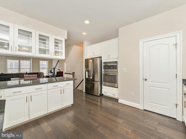 kitchen featuring white cabinetry, dark wood-type flooring, and stainless steel appliances