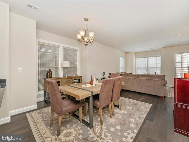 dining room featuring a chandelier and dark hardwood / wood-style floors