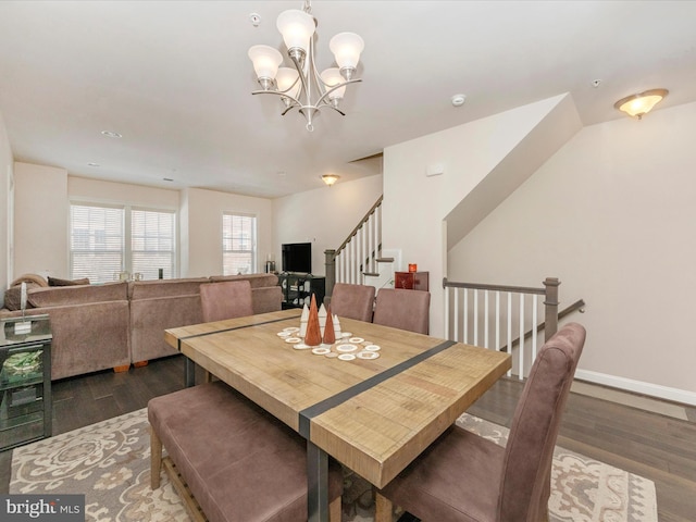 dining room featuring dark hardwood / wood-style flooring and an inviting chandelier