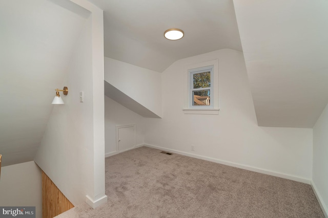 bonus room featuring light carpet and lofted ceiling