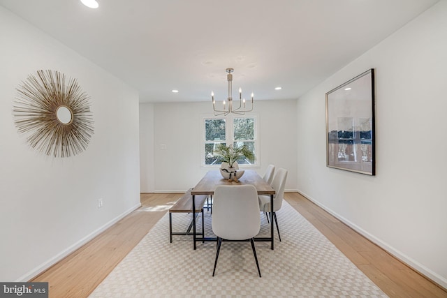 dining space with recessed lighting, wood finished floors, baseboards, and a chandelier