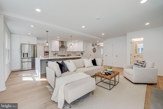 living room featuring light wood-style flooring and recessed lighting