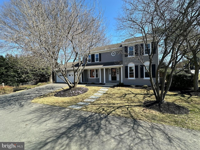 view of front of home with aphalt driveway and an attached garage