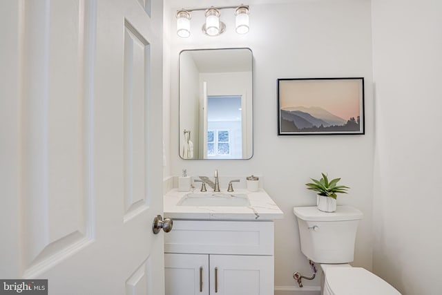 bathroom with toilet and vanity