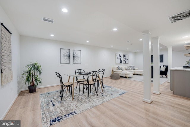 dining area featuring recessed lighting, visible vents, ornate columns, and light wood finished floors