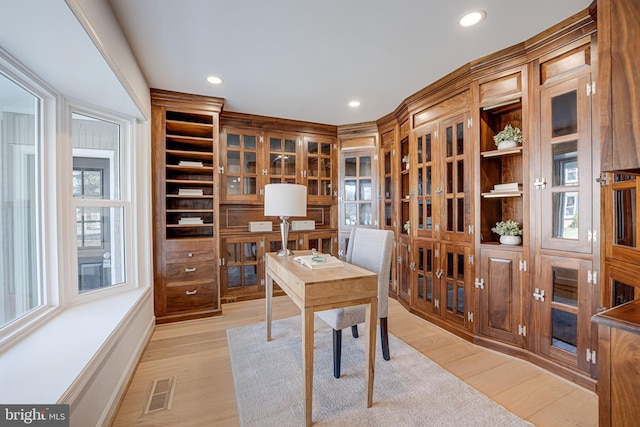 office space with light wood-type flooring, visible vents, baseboards, and recessed lighting