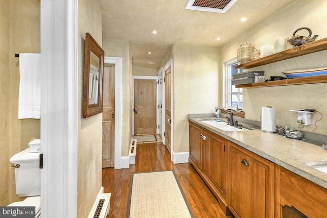 bathroom featuring hardwood / wood-style floors, vanity, and toilet