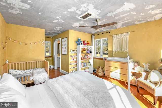 bedroom featuring wood-type flooring and ceiling fan