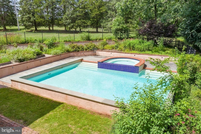 view of swimming pool featuring an in ground hot tub