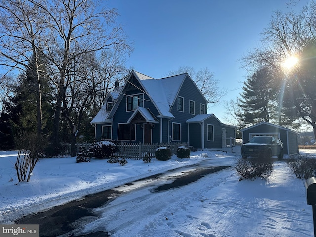 view of front of property with a garage and an outbuilding