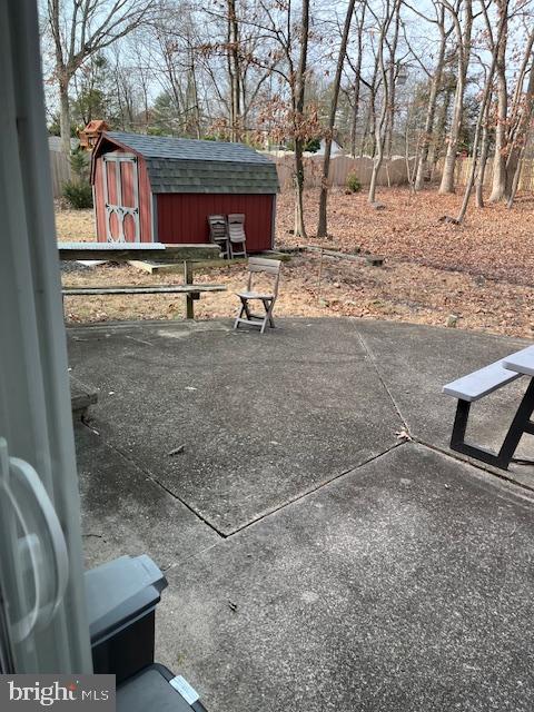 view of patio with a storage shed