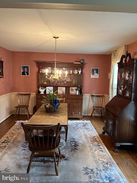 dining area with a chandelier and dark hardwood / wood-style flooring