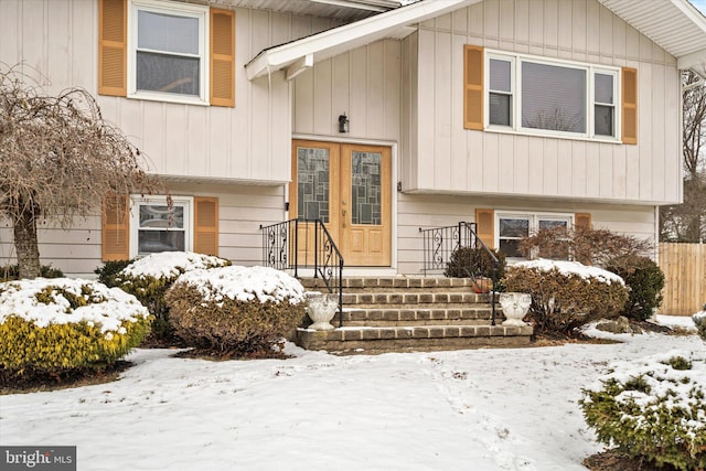 view of snow covered property entrance