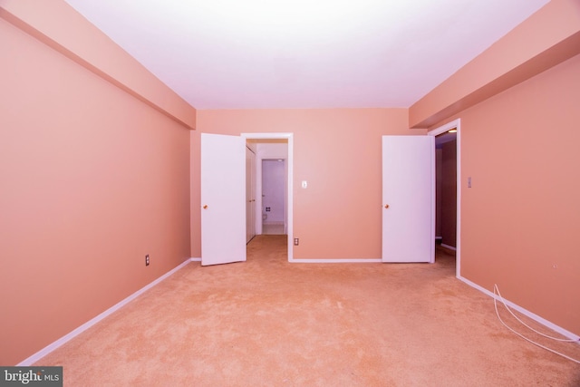 unfurnished bedroom with light colored carpet