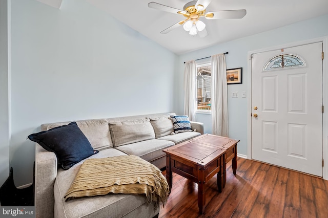 living room with ceiling fan, vaulted ceiling, and dark hardwood / wood-style flooring