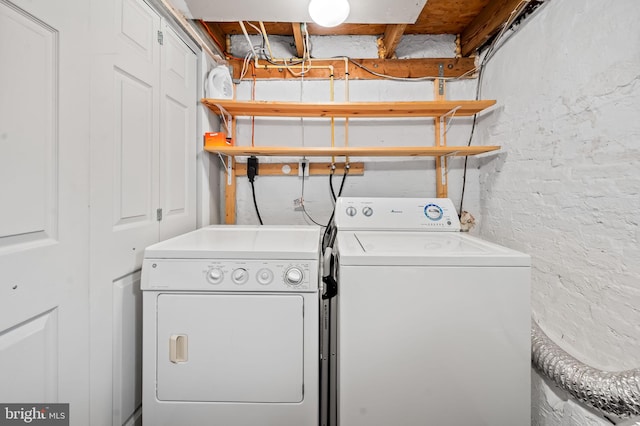 clothes washing area with washer and dryer