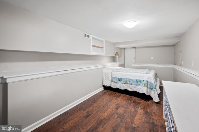 bedroom with dark hardwood / wood-style floors