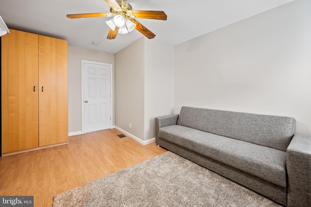 living area featuring ceiling fan and light hardwood / wood-style flooring