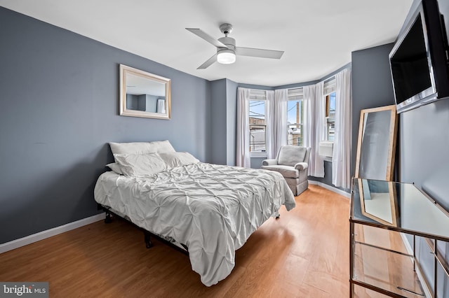 bedroom with wood-type flooring and ceiling fan