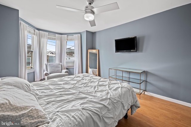 bedroom with hardwood / wood-style floors and ceiling fan