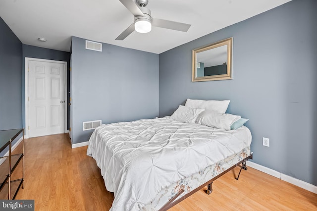 bedroom with light hardwood / wood-style floors and ceiling fan