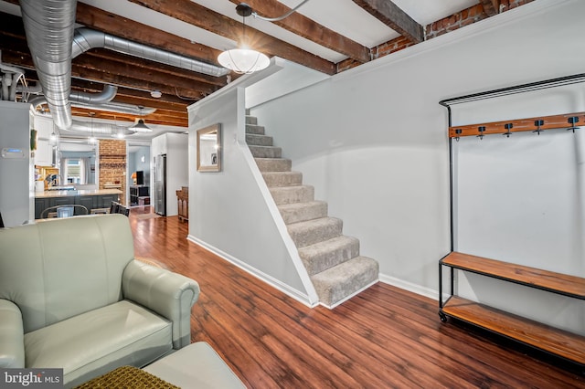 interior space featuring hardwood / wood-style floors and beam ceiling