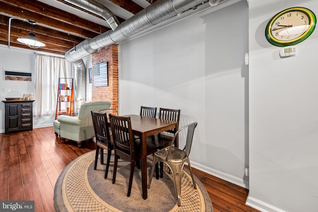 dining area featuring dark wood-type flooring