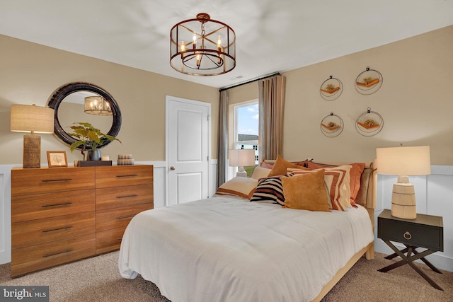 bedroom with light carpet and an inviting chandelier