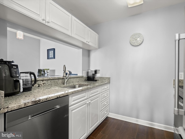 kitchen with light stone countertops, sink, stainless steel dishwasher, and white cabinets