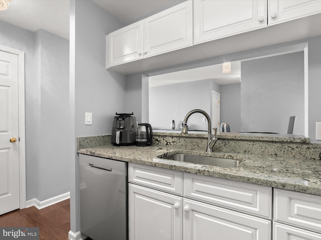 kitchen with white cabinetry, light stone countertops, sink, and stainless steel dishwasher