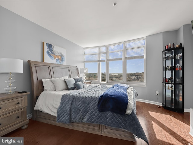 bedroom with dark wood-type flooring