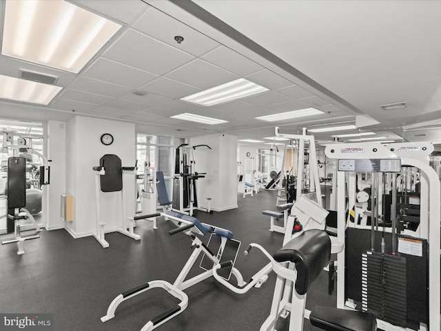 exercise room with a drop ceiling and plenty of natural light