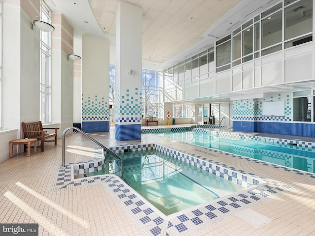 view of swimming pool featuring an indoor hot tub