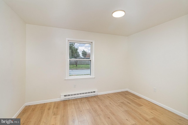 unfurnished room featuring light hardwood / wood-style flooring and a baseboard radiator