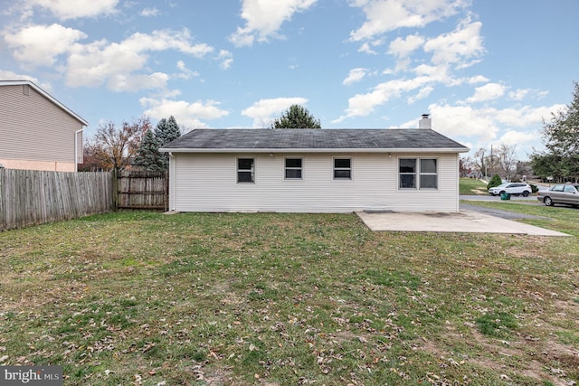 rear view of house with a patio area and a yard