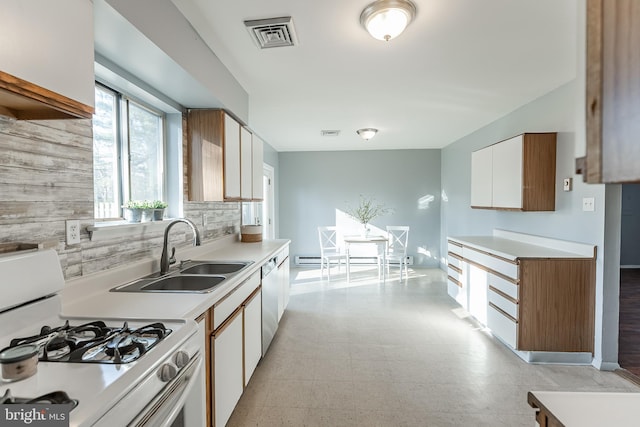 kitchen featuring white cabinets, stainless steel dishwasher, white gas range, and sink