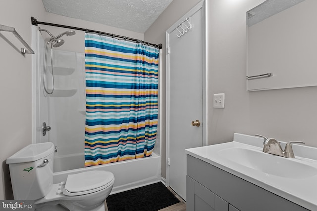 bathroom with toilet, shower / bathtub combination with curtain, a textured ceiling, and vanity